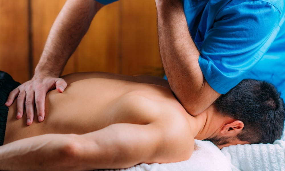 Physical therapist helping patient with frozen shoulder mobility exercises