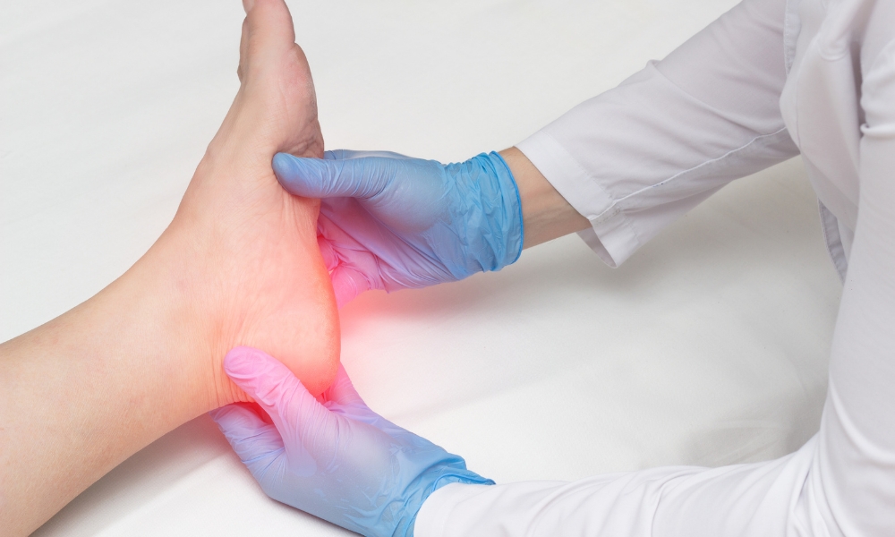 Patient performing plantar fasciitis stretching exercises during physical therapy