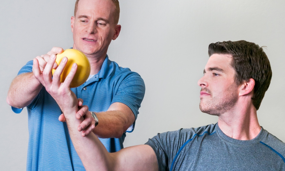 Patient performing shoulder therapy exercises for rotator cuff injury recovery